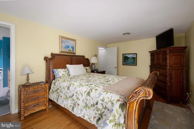 a bedroom with a bed and a flat screen television