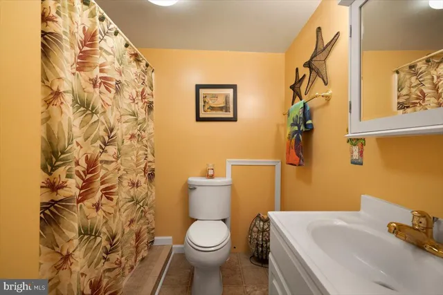 a white toilet sitting next to a bathroom sink