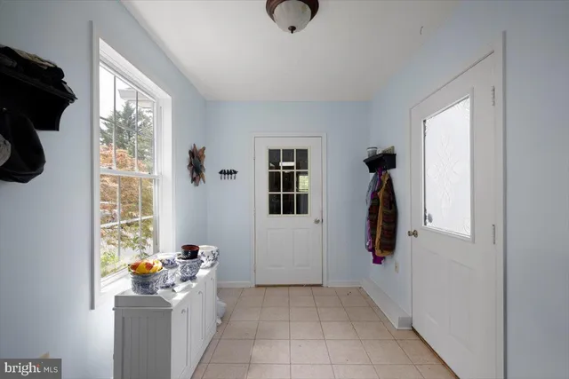 a view of entryway with workspace and windows