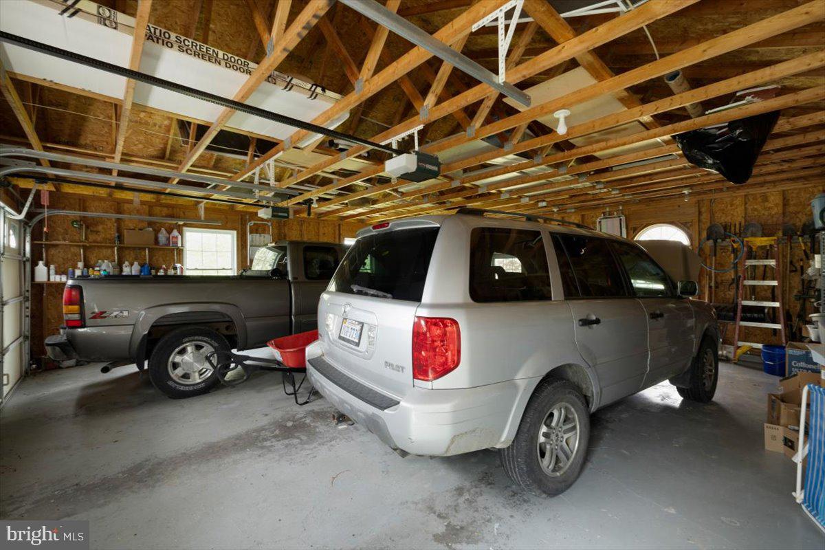 1049 Laurel Grove Road Winchester, VA 22602 - Photo 30 of 42 a car and bike parked in a garage