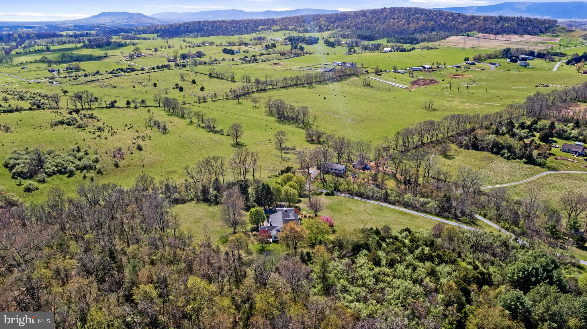 1049 Laurel Grove Road Winchester, VA 22602 - Photo 36 of 39 an aerial view of a houses with a lush green hillside