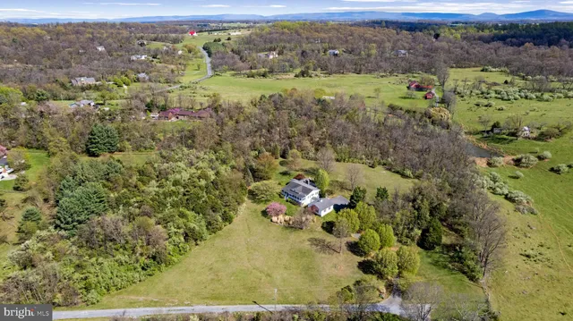 an aerial view of a houses with a yard