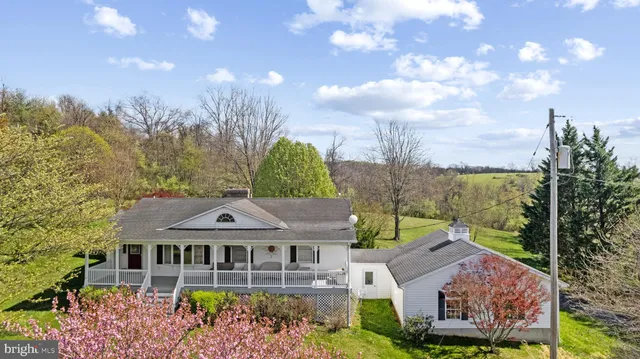 a aerial view of a house with a big yard and large trees