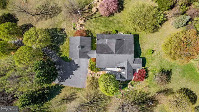 an aerial view of a house with a yard and garden