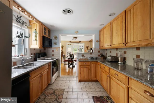 a kitchen with stainless steel appliances granite countertop counter space a sink and cabinets