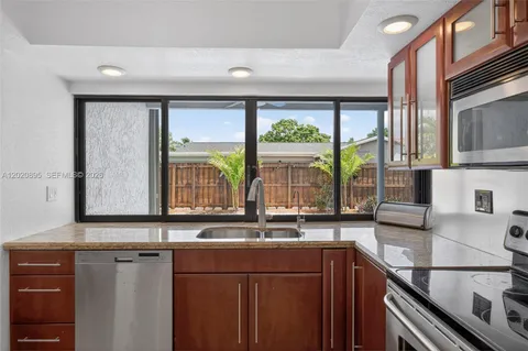 a kitchen with a sink and a large window