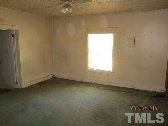 2543 Leasburg Road Roxboro, NC 27574 - Photo 12 of 18 an empty room with a door