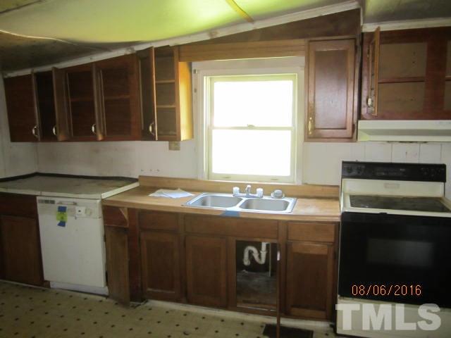 2543 Leasburg Road Roxboro, NC 27574 - Photo 9 of 18 a kitchen with a stove and a refrigerator