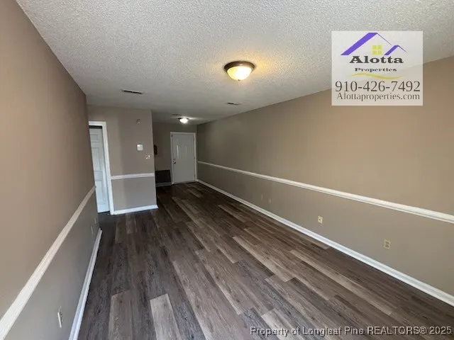 a view of room with wooden floor