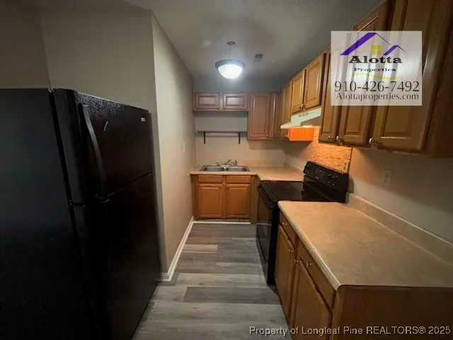 a kitchen with stainless steel appliances a refrigerator and a stove