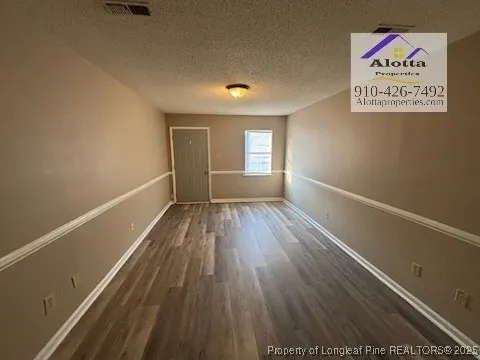 a view of hallway with wooden floor