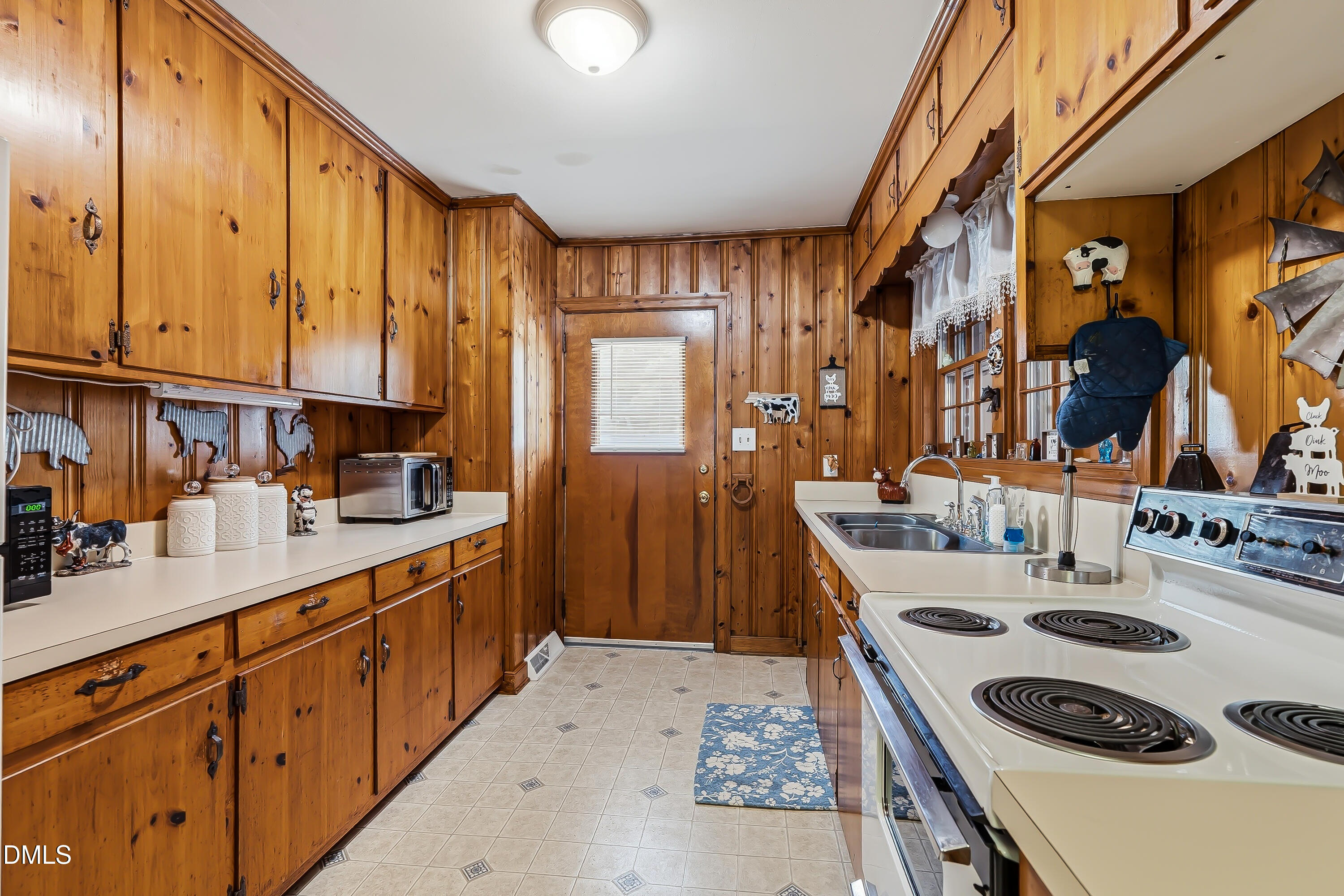 4967 Highway 581 Spring Hope, NC 27882 - Photo 24 of 44 a kitchen with a sink a stove and a refrigerator