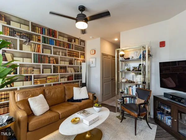 a living room with furniture workspace and a flat screen tv