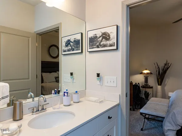 a bathroom with a granite countertop sink and a mirror