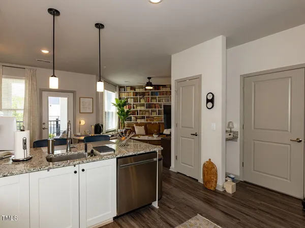 a kitchen with sink refrigerator and cabinets