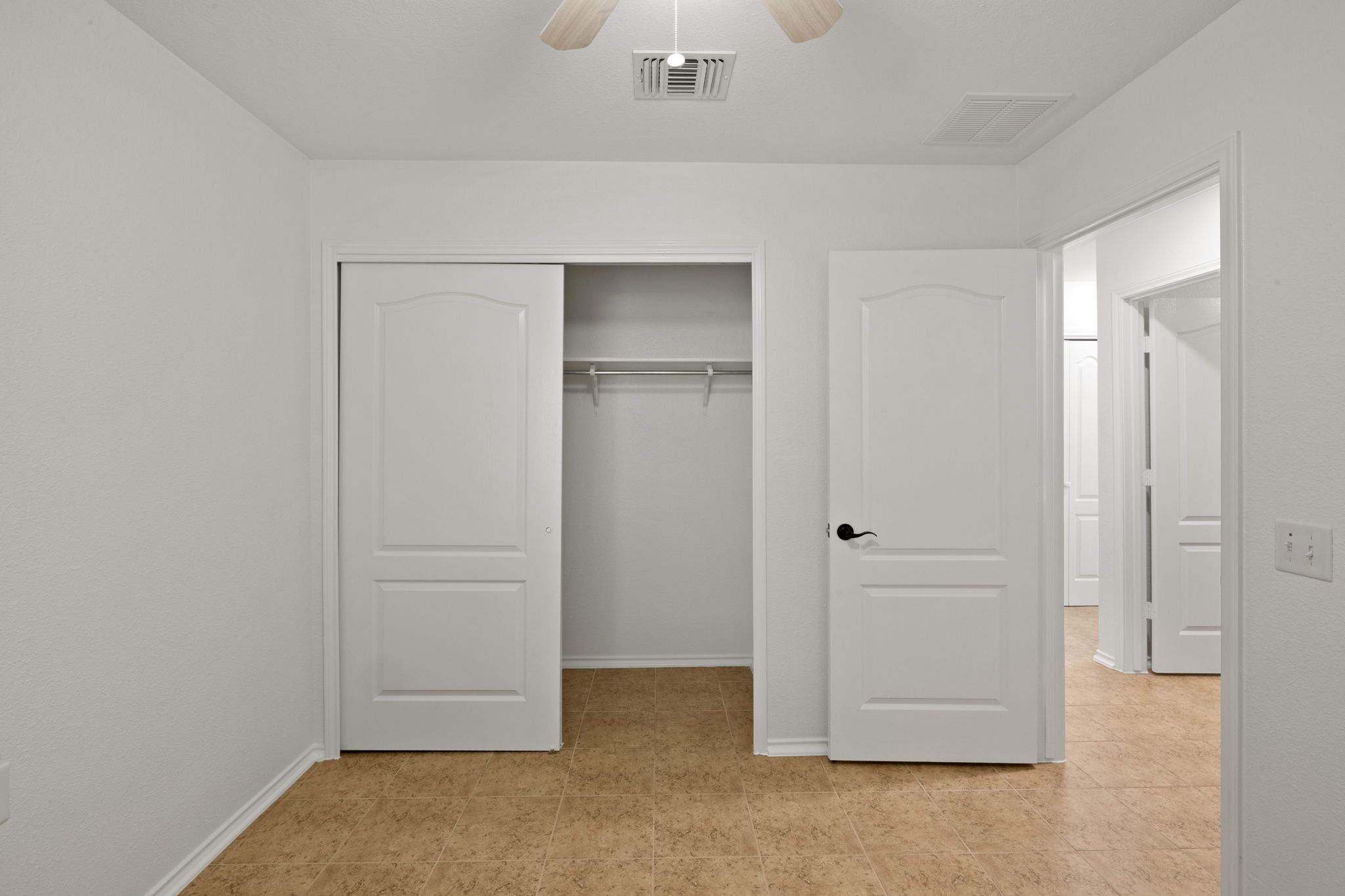 8825 Stambourne Street Austin, TX 78747 - Photo 18 of 37 Bedroom featuring a closet and a ceiling fan