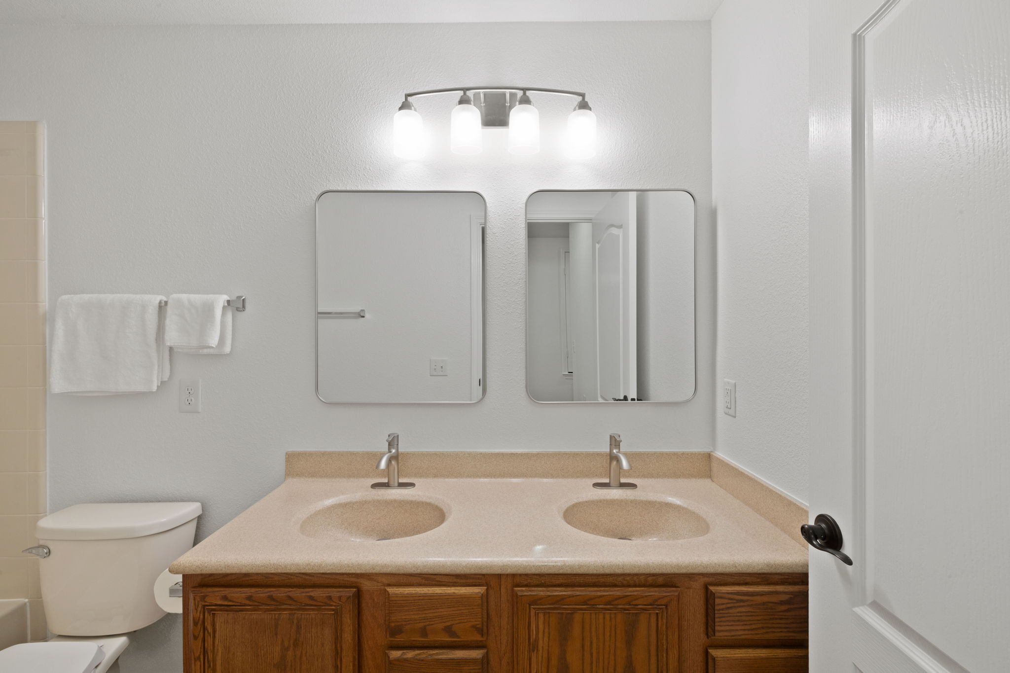 8825 Stambourne Street Austin, TX 78747 - Photo 20 of 37 a bathroom with 2 sink and a toilet