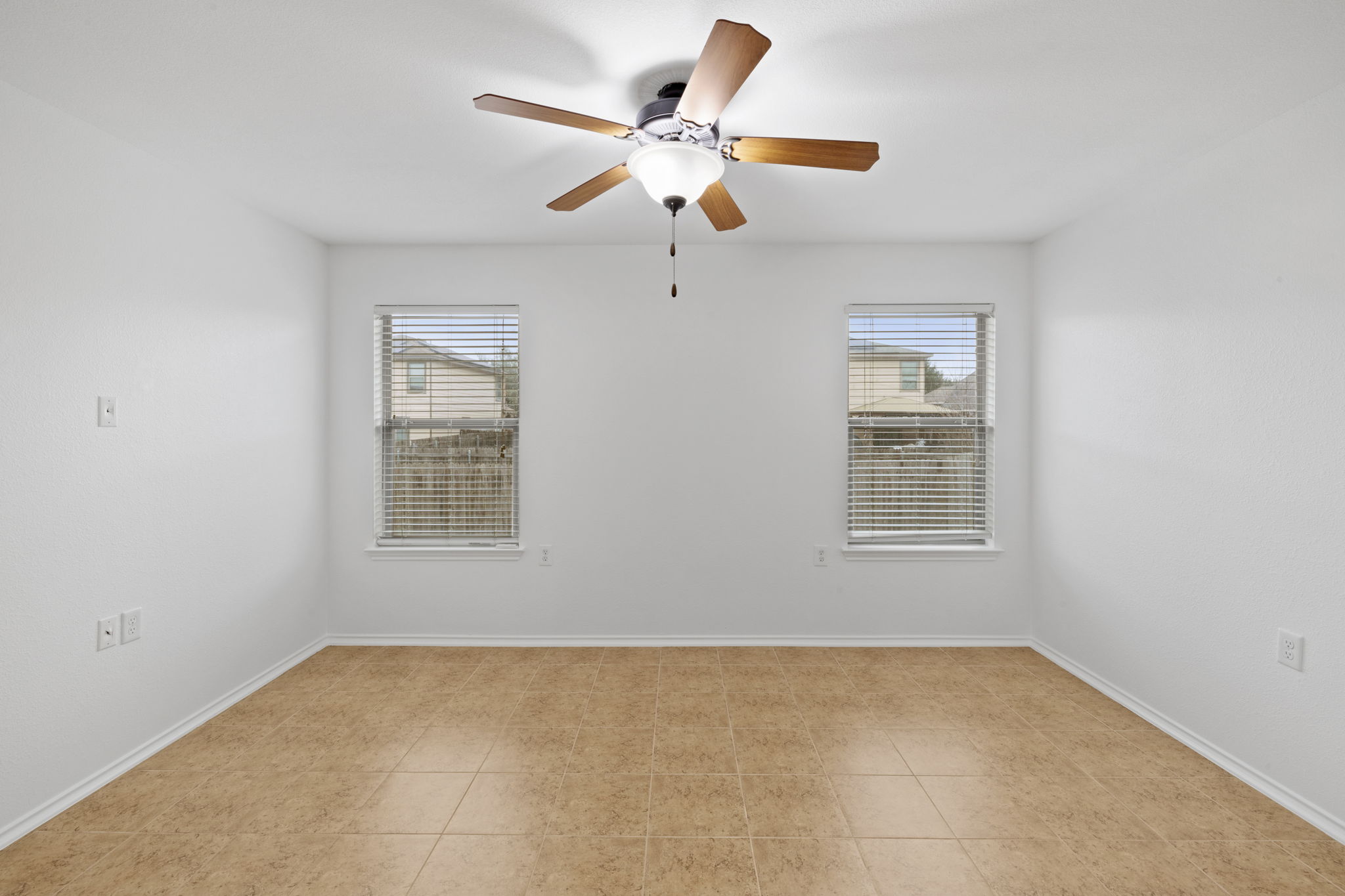 8825 Stambourne Street Austin, TX 78747 - Photo 22 of 37 an empty room with windows and fan