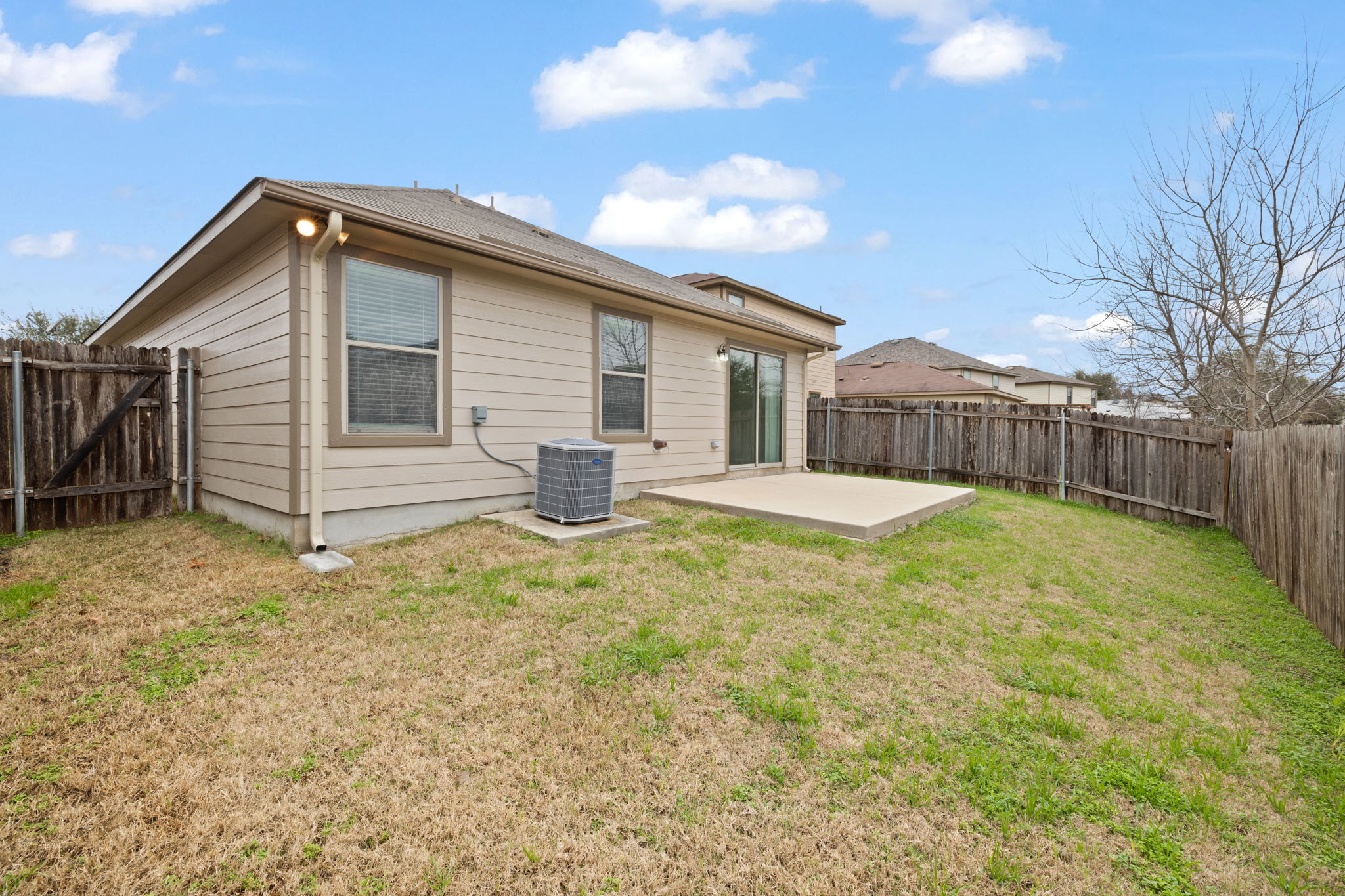 8825 Stambourne Street Austin, TX 78747 - Photo 31 of 37 a view of a house with a backyard and a patio