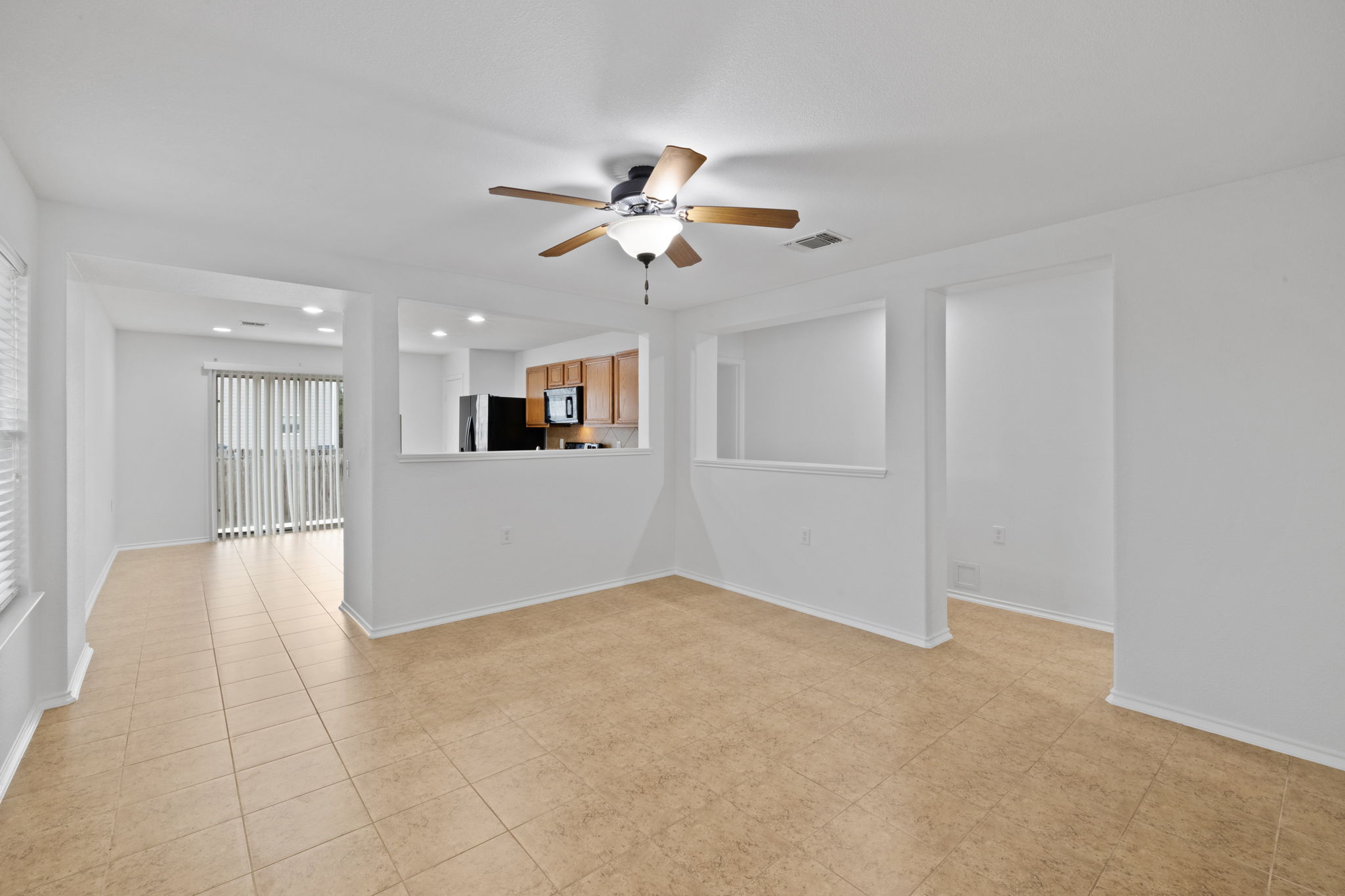 8825 Stambourne Street Austin, TX 78747 - Photo 4 of 37 Unfurnished living room featuring a ceiling fan and recessed lighting
