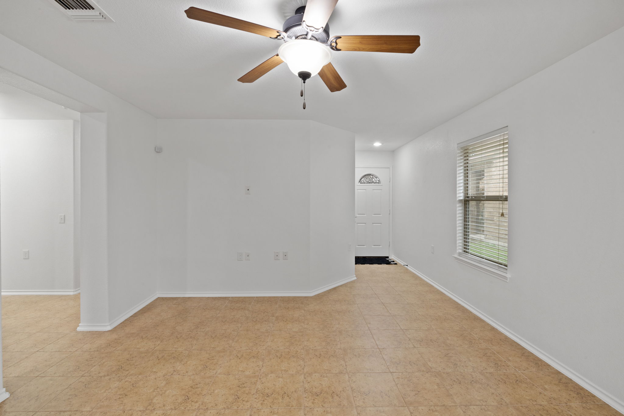 8825 Stambourne Street Austin, TX 78747 - Photo 7 of 37 an empty room with windows and fan