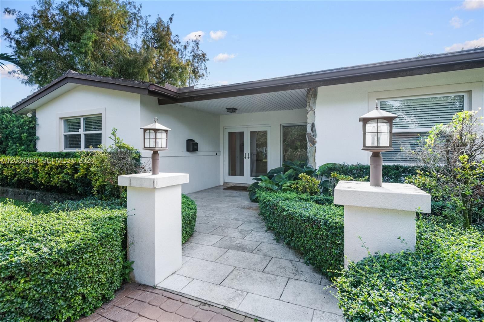 7360 Southwest 115th Street Pinecrest, FL 33156 - Photo 3 of 18 a house view with a garden space