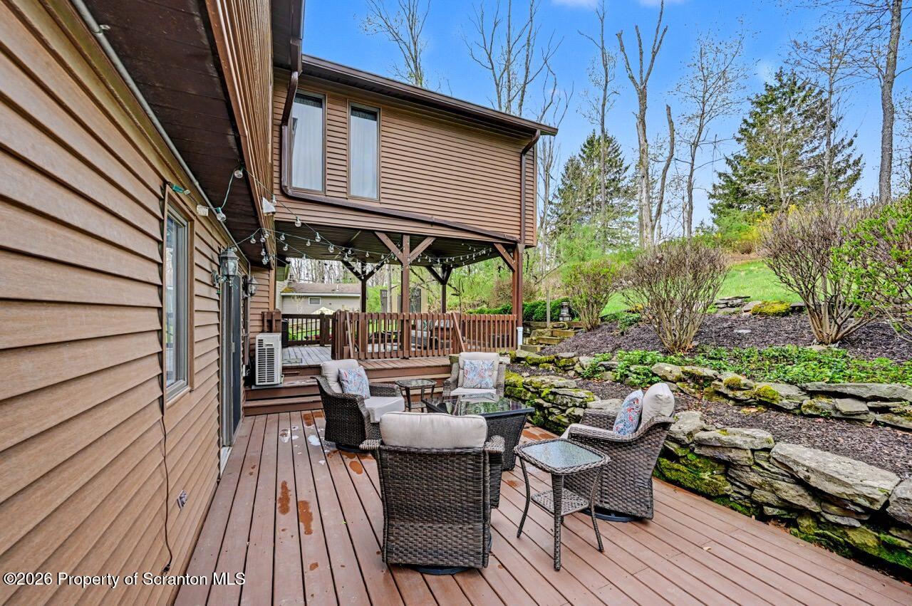 719 Scott Road Clarks Summit, PA 18411 - Photo 48 of 51 a view of a chairs and table on the wooden deck