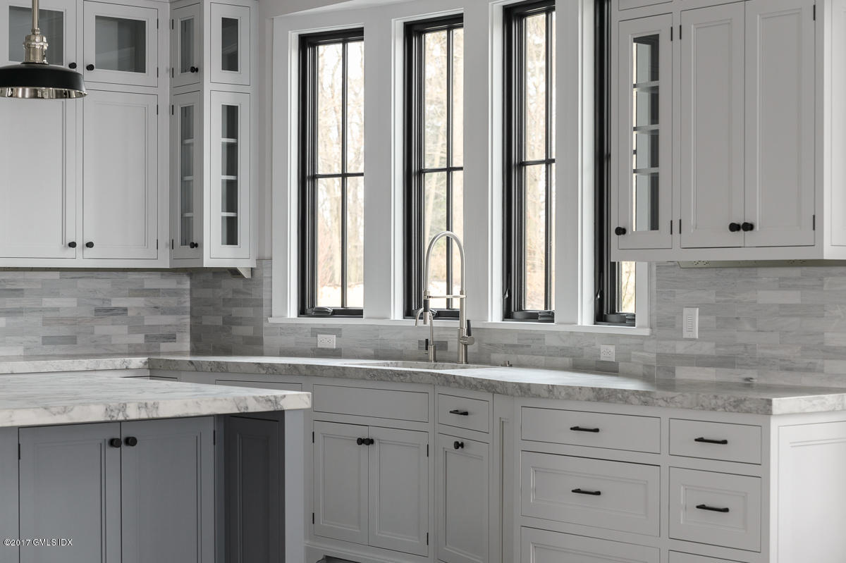 649 River Road Cos Cob, CT 06807 - Photo 14 of 27 a sink with white cabinets