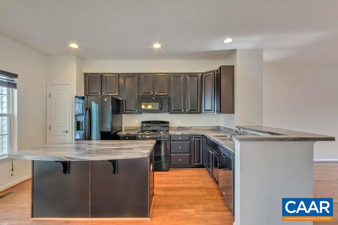 415 Rolkin Road Charlottesville, VA 22911 - Photo 3 of 21 a kitchen with stainless steel appliances granite countertop a stove a sink dishwasher and a refrigerator
