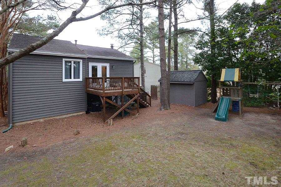 2401 Boothbay Court Raleigh, NC 27613 - Photo 2 of 21 Showing deck, wired shed with 2 level storage, play set conveys. The spacious yard is fully fenced and landscaped with a combination of flowering shrubs and trees, as well as hardwood and pine.