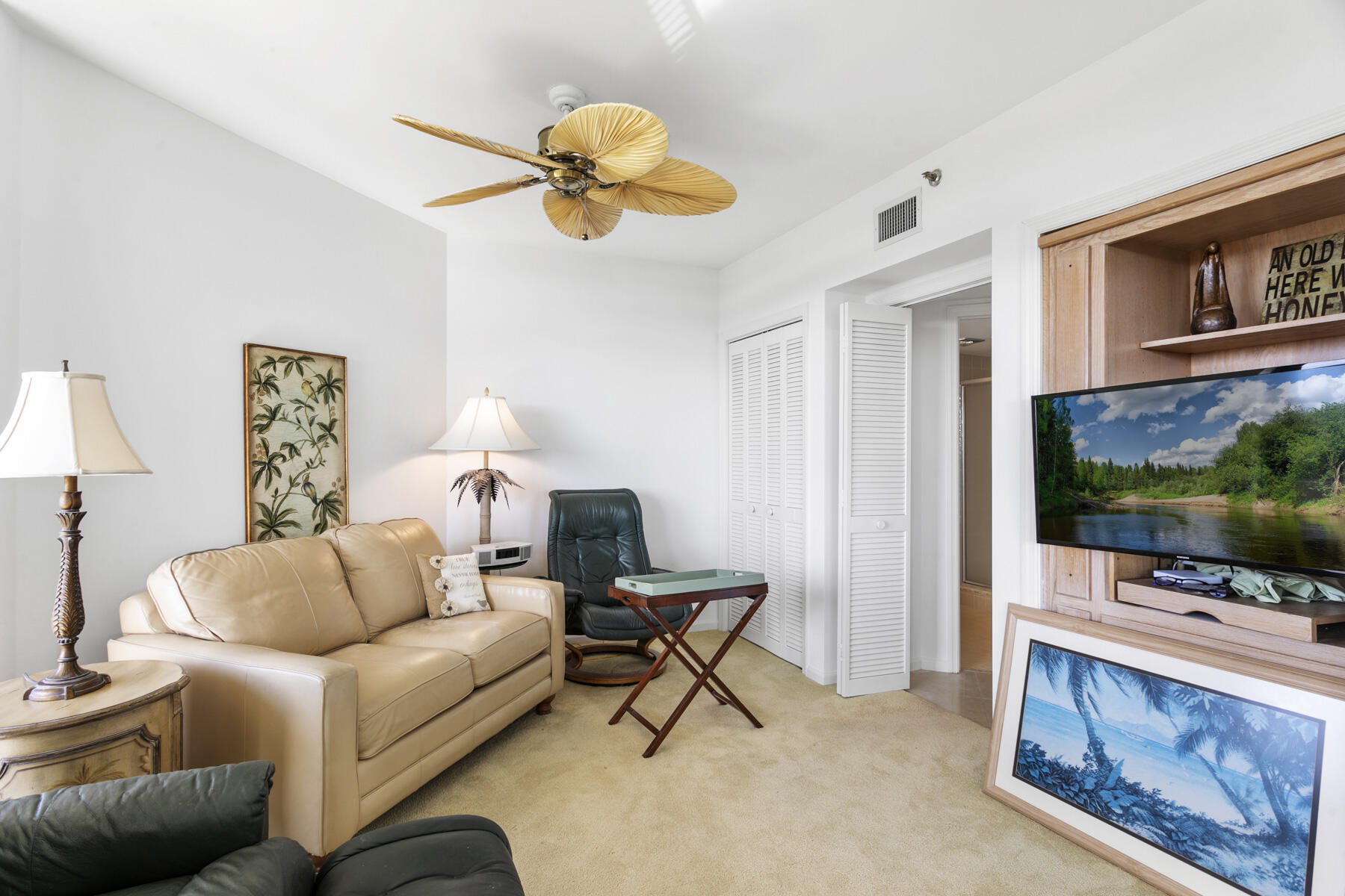 3322 Casseekey Island Road, Unit 504 Jupiter, FL 33477 - Photo 22 of 46 a living room with furniture and a flat screen tv