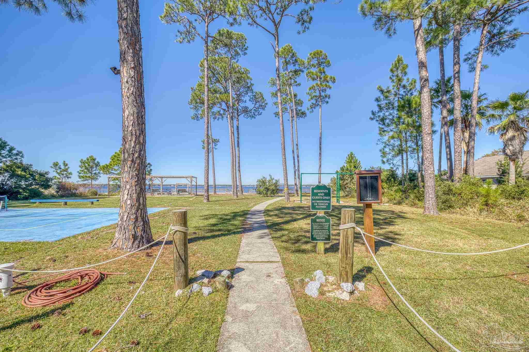 5426 North Shore Road Pensacola, FL 32507 - Photo 13 of 53 a view of an ocean with a swimming pool