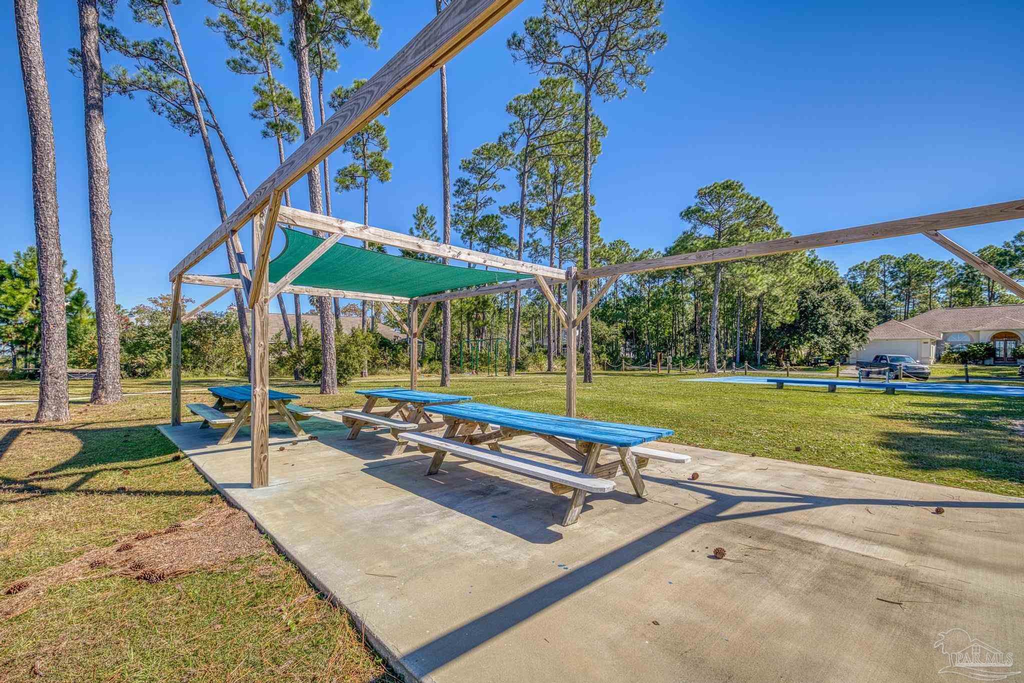 5426 North Shore Road Pensacola, FL 32507 - Photo 20 of 53 a view of a patio with a table and chairs under an umbrella