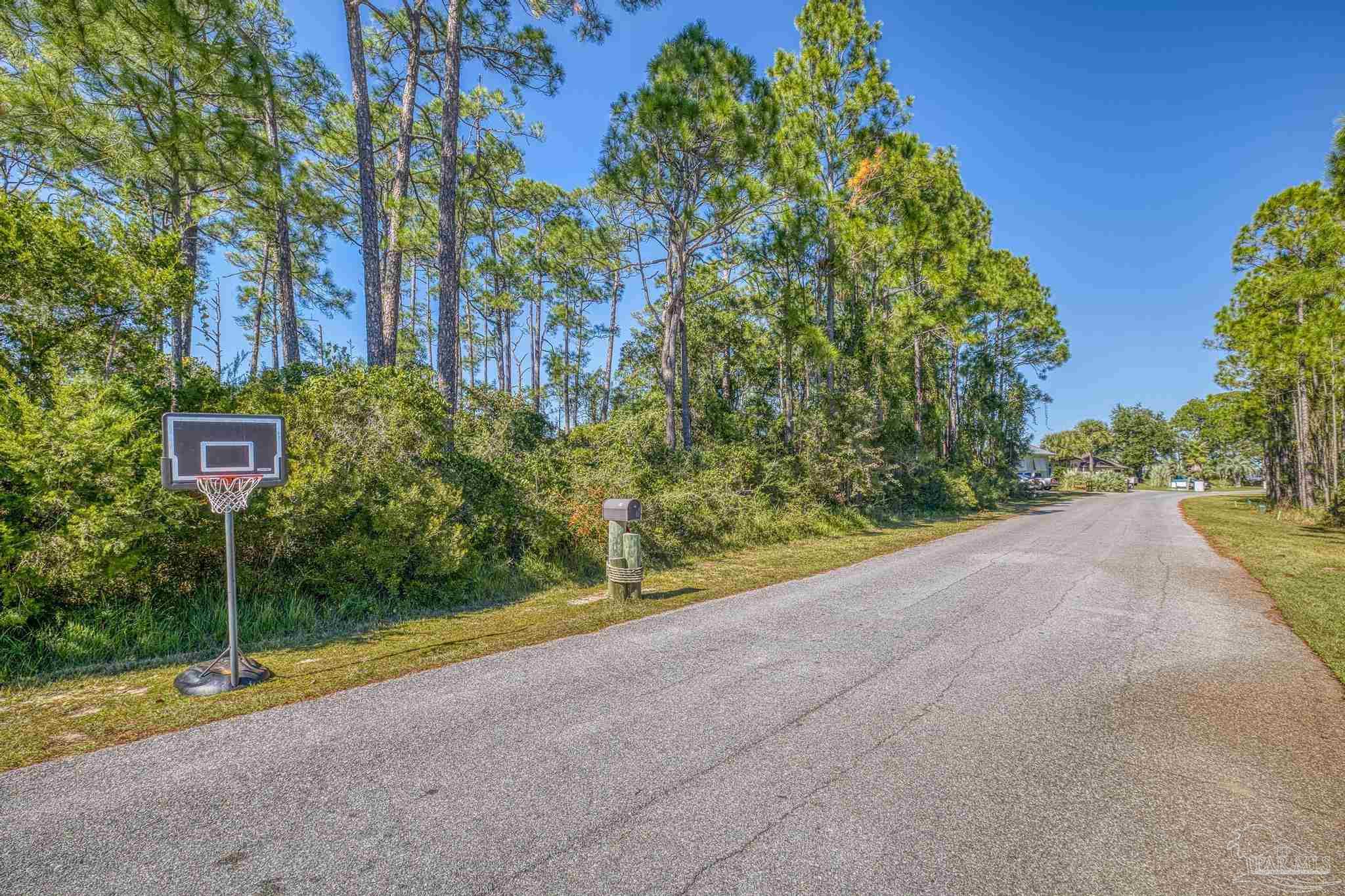 5426 North Shore Road Pensacola, FL 32507 - Photo 21 of 53 a view of a street with a building and a street sign