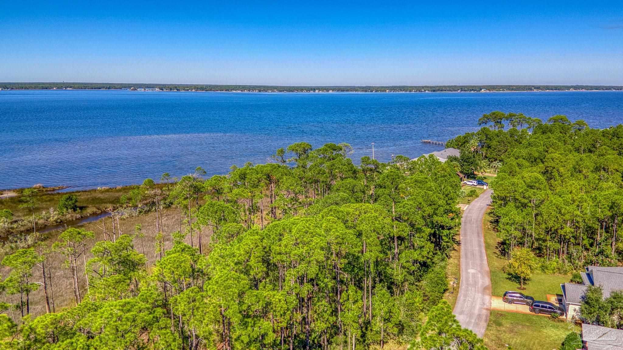 5426 North Shore Road Pensacola, FL 32507 - Photo 25 of 53 a view of a lake with a city