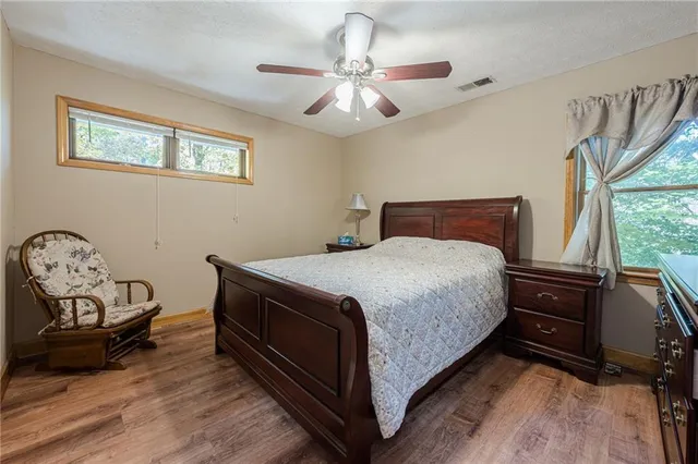 a spacious bedroom with two beds and a chandelier