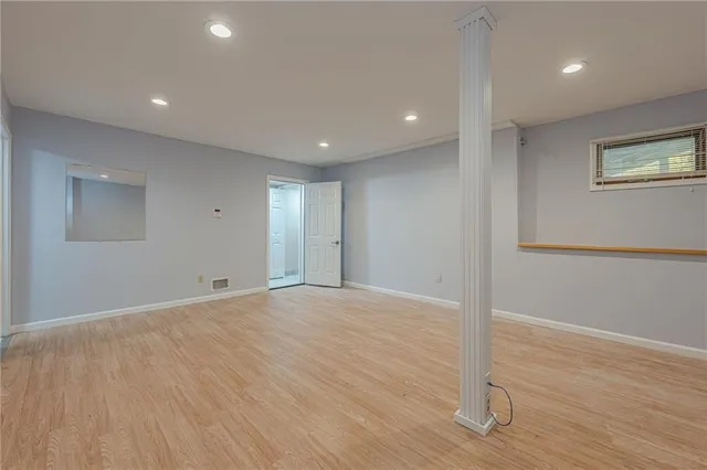 a bathroom with a sink shower and a mirror