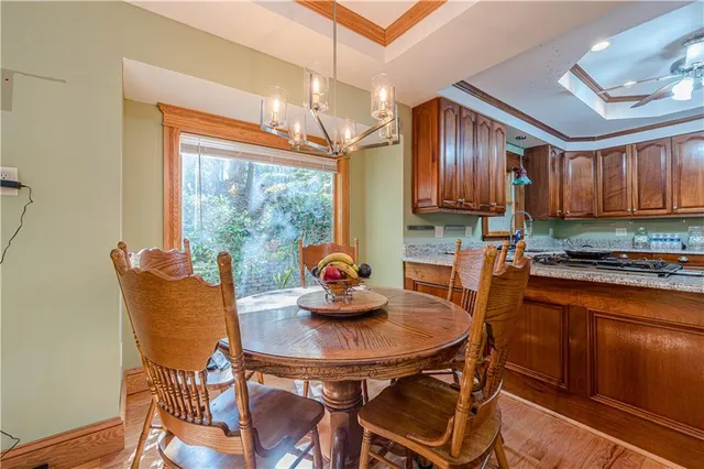 a kitchen with granite countertop stainless steel appliances a stove sink and cabinets