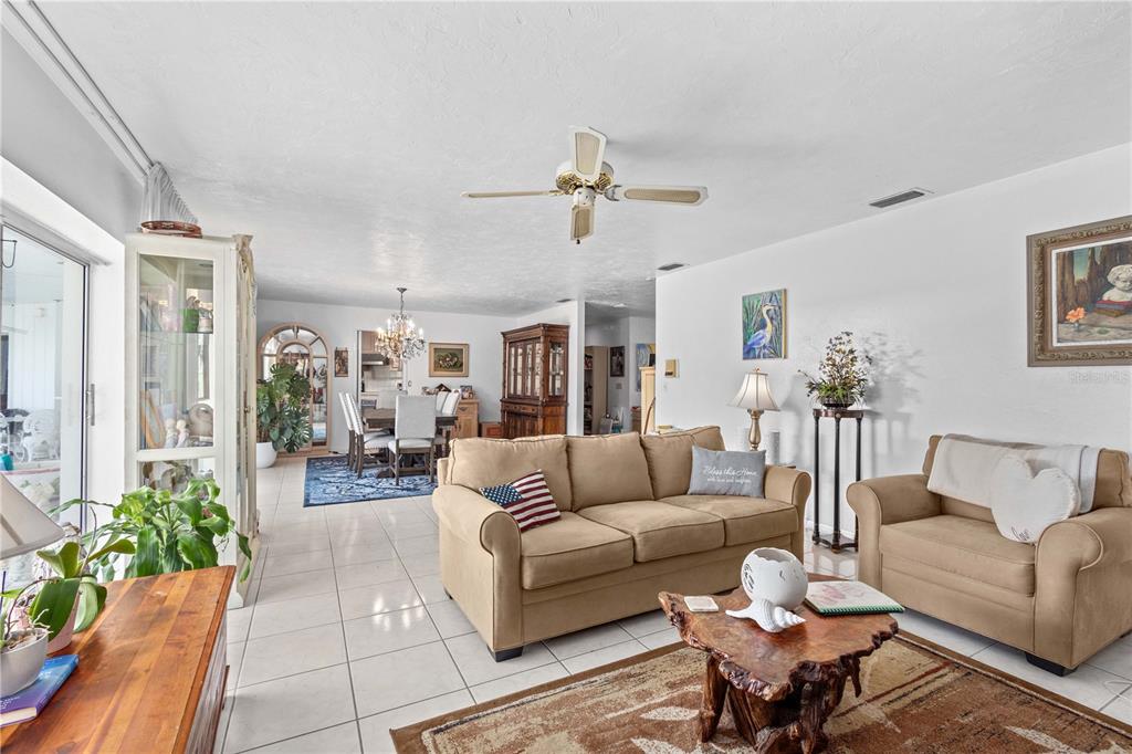 6937 Midnight Pass Road Sarasota, FL 34242 - Photo 12 of 30 a living room with furniture and a chandelier