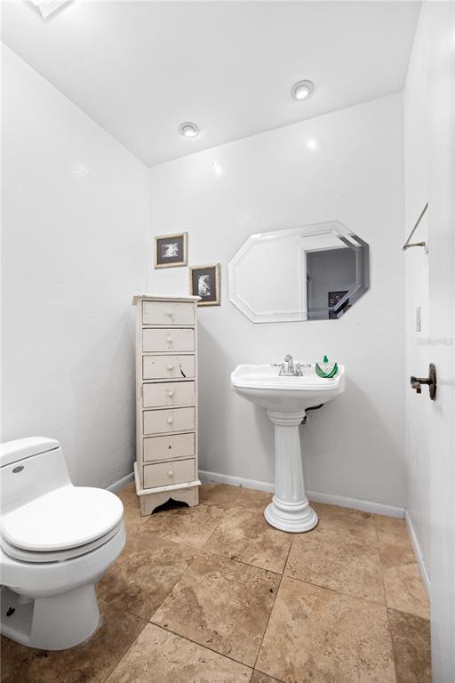 6937 Midnight Pass Road Sarasota, FL 34242 - Photo 16 of 30 a bathroom with a toilet sink and mirror