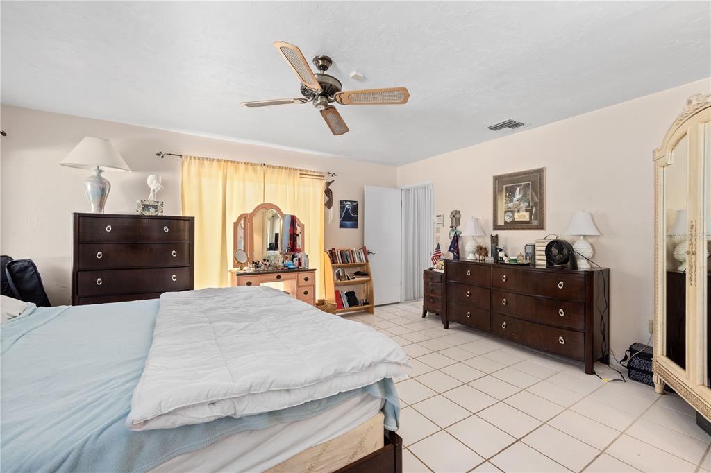 6937 Midnight Pass Road Sarasota, FL 34242 - Photo 18 of 30 a bed room with a bed and a dresser