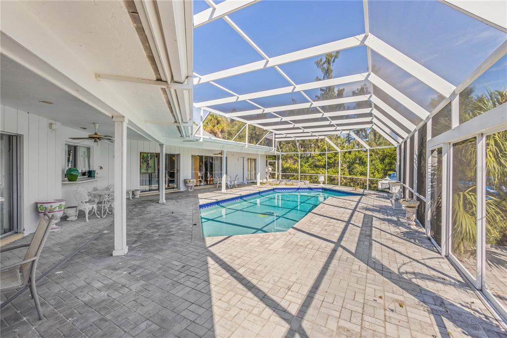 6937 Midnight Pass Road Sarasota, FL 34242 - Photo 20 of 30 a view of a house with a yard and furniture