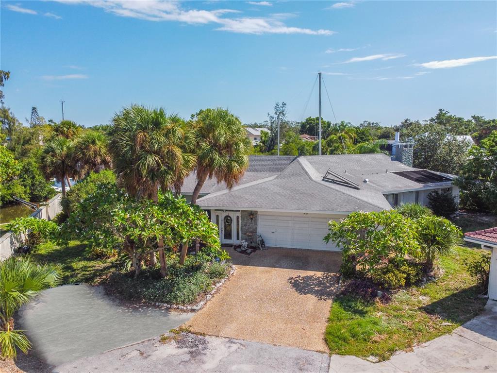 6937 Midnight Pass Road Sarasota, FL 34242 - Photo 2 of 30 a view of a house with a yard and potted plants