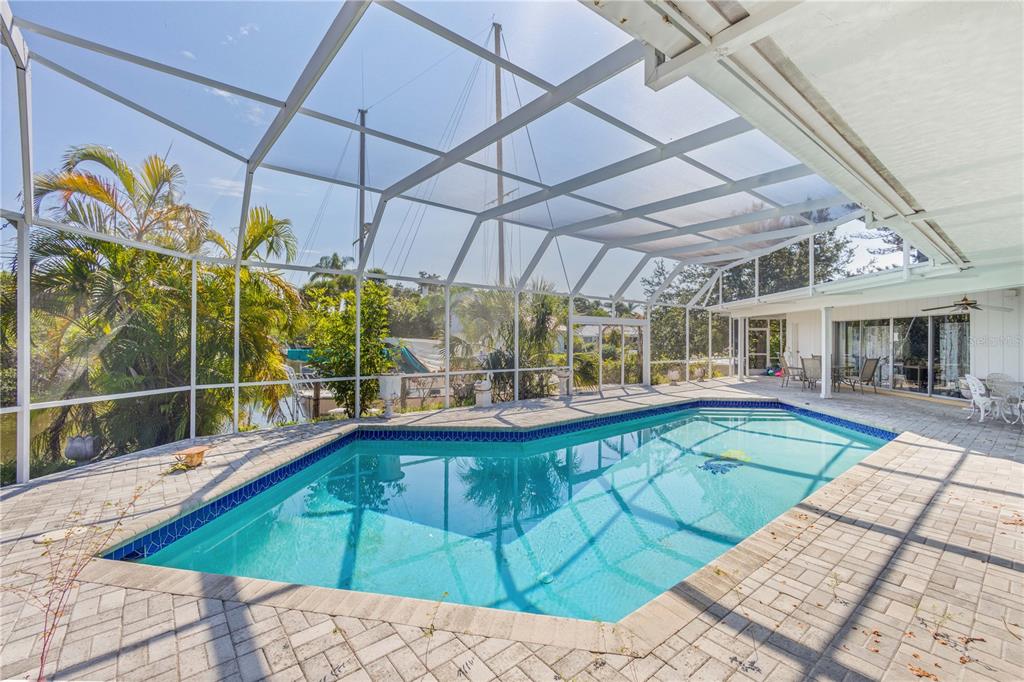 6937 Midnight Pass Road Sarasota, FL 34242 - Photo 21 of 30 a view of a swimming pool with a patio