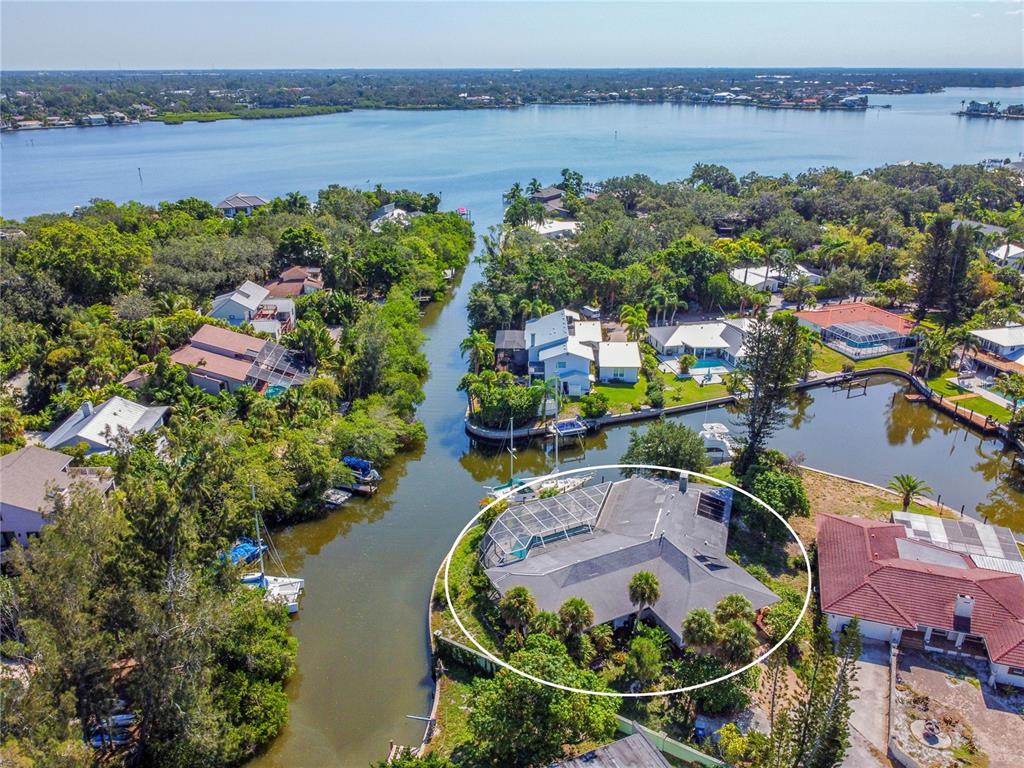 6937 Midnight Pass Road Sarasota, FL 34242 - Photo 3 of 30 an aerial view of lake and residential houses with outdoor space