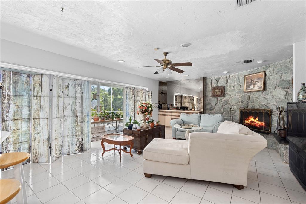 6937 Midnight Pass Road Sarasota, FL 34242 - Photo 4 of 30 a living room with furniture and a fireplace