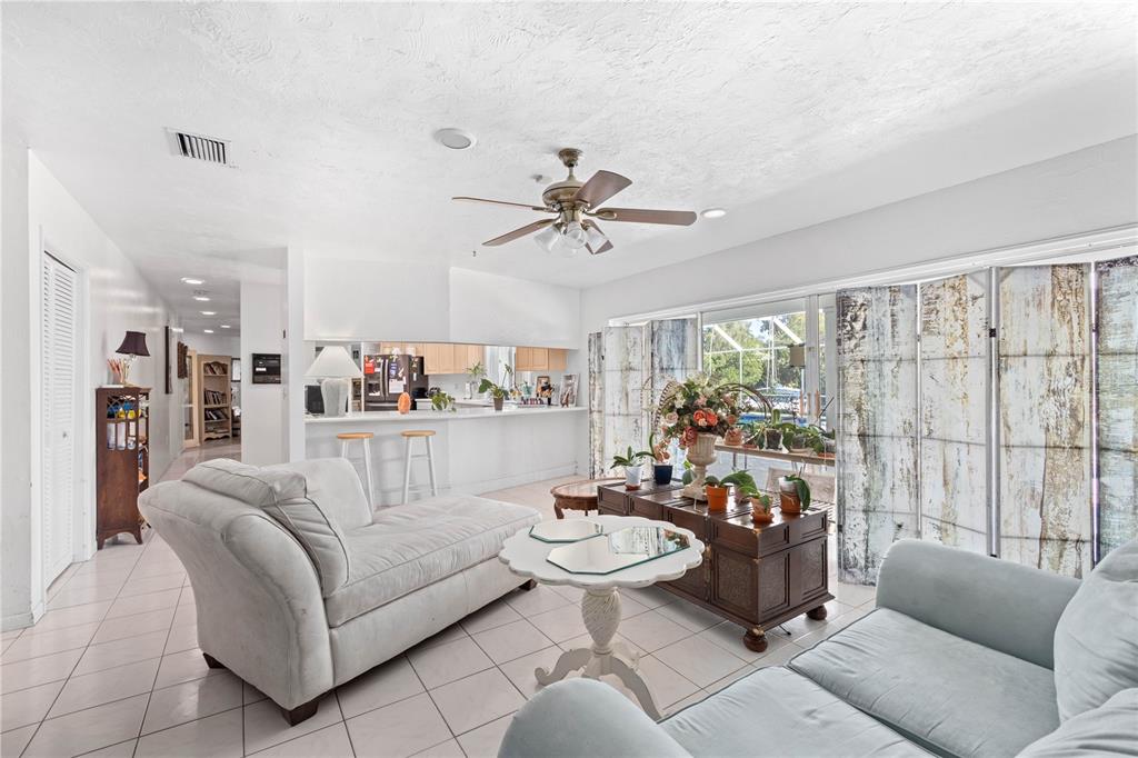 6937 Midnight Pass Road Sarasota, FL 34242 - Photo 5 of 30 a living room with furniture and a large window with kitchen view