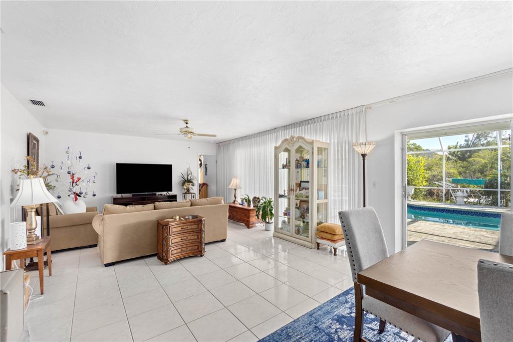 6937 Midnight Pass Road Sarasota, FL 34242 - Photo 6 of 30 a living room with furniture and a flat screen tv