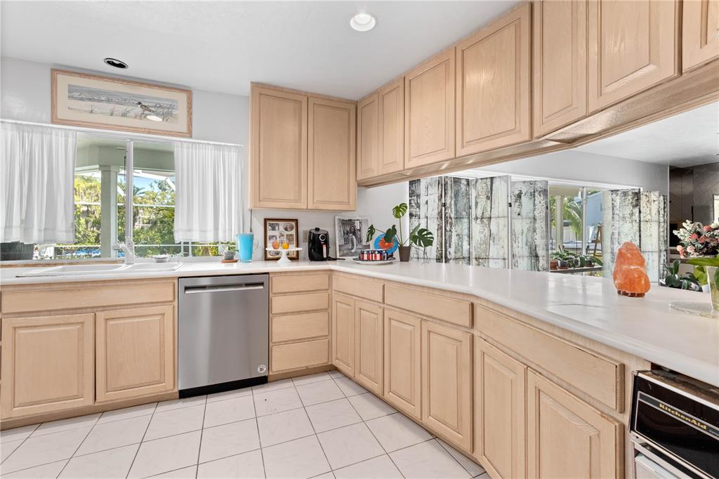 6937 Midnight Pass Road Sarasota, FL 34242 - Photo 8 of 30 a kitchen with white cabinets and white appliances