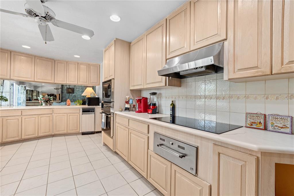 6937 Midnight Pass Road Sarasota, FL 34242 - Photo 9 of 30 a kitchen with white cabinets and white appliances
